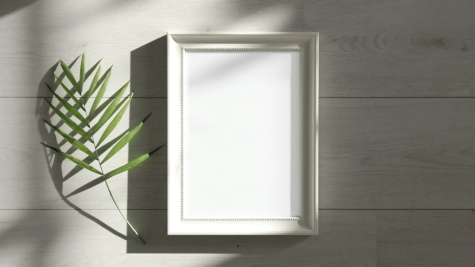 Green-leafed beside white photo frame